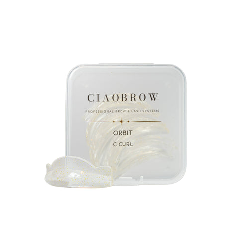 CiaoBrow Orbit C Curl professional brow and lash system, featuring a clear plastic case with gold lettering and a single clear curled lash strip in front, set against a solid white background.